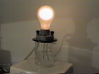 Light bulb showing conductivity of salt water. [solnex5.JPG]